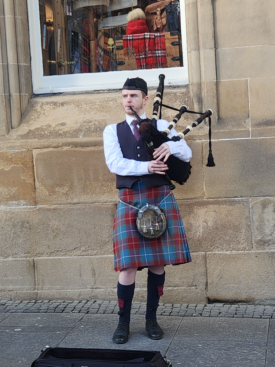 Street bagpiper performing in Edinburgh